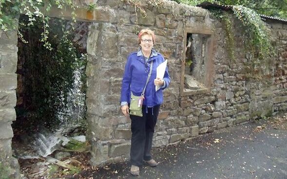 PictureKate standing in front of the ruins of one room stone hovels that lined Pig Foot Lane in Templemore, Co. 