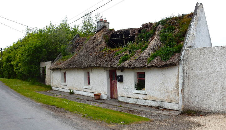 Irish cottage with damaged thatch roof