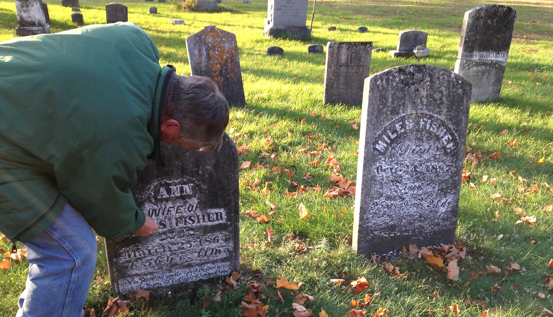 Mike chalking two gravestones of his Fisher ancestors.